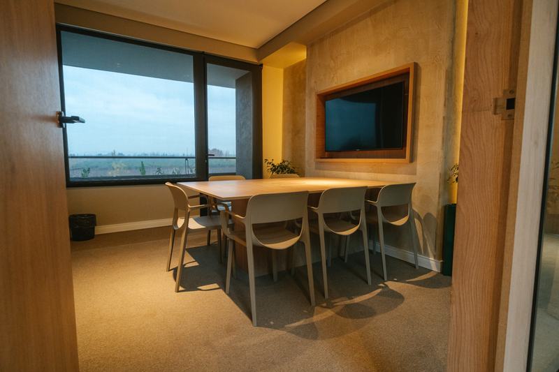 Sala de reuniones equipada con pantalla y vista al exterior en Foresta